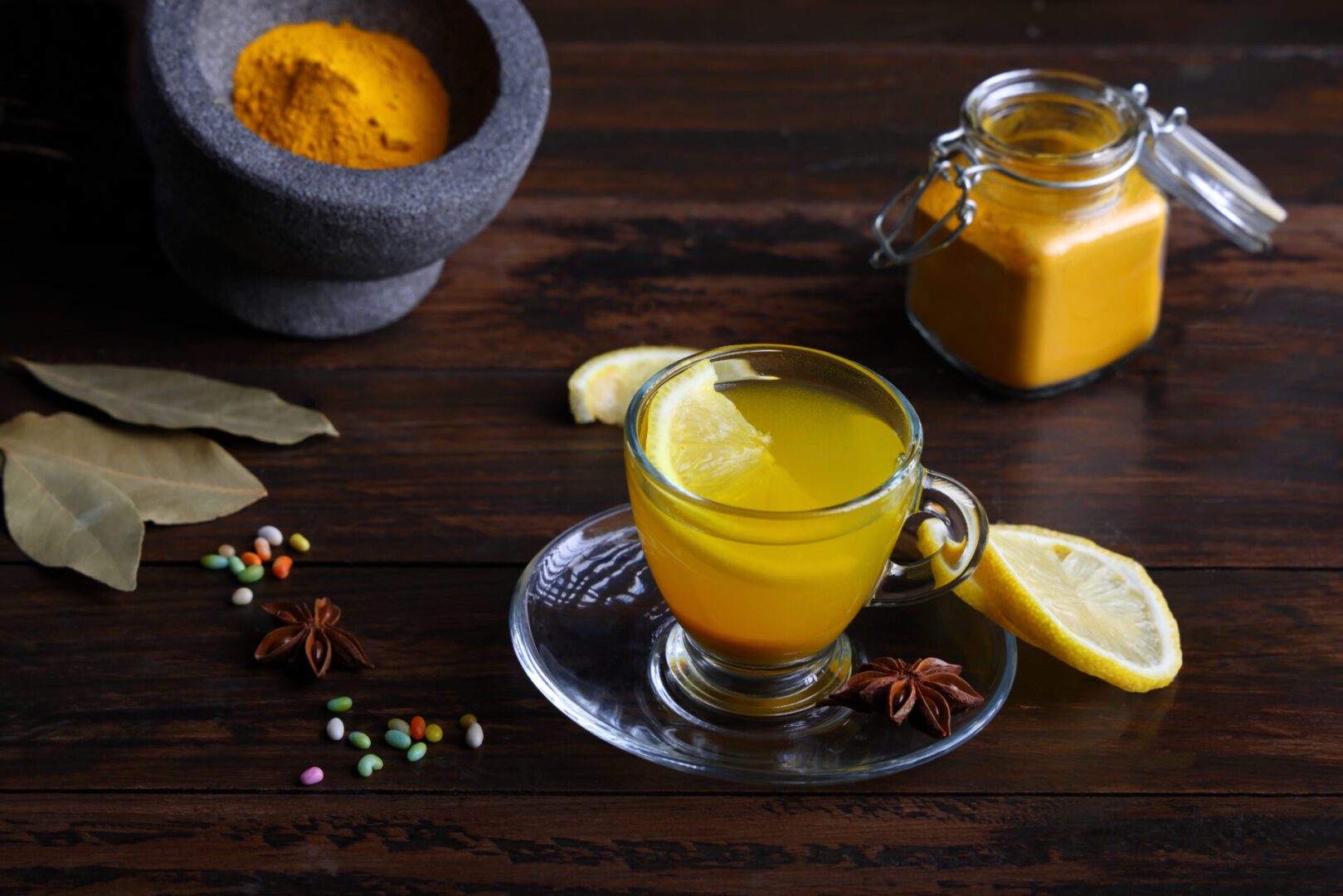 Glass cup of turmeric tea on table